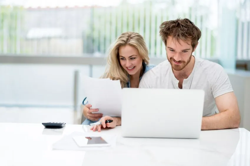 Person reviewing household budget and financial paperwork at a table